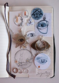 a notebook with a variety of objects on it