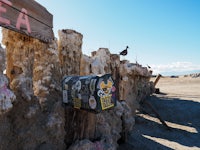 a mailbox on a post in the desert