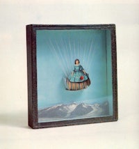 a doll in a box with a parachute