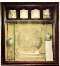 a glass display case with a map of the moon