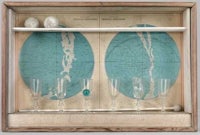 a wooden frame with two glasses and a map