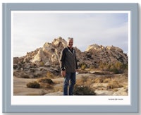 a man standing in front of rocks in joshua tree national park