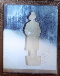 a picture of a man in a coat standing in the snow