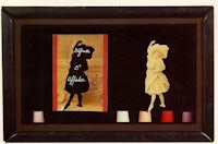 a black frame with a picture of a woman in a dress