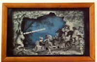 a wooden frame with a picture of people in the woods